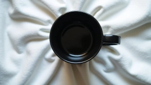 Black Ceramic Mug On Crumpled White Linen