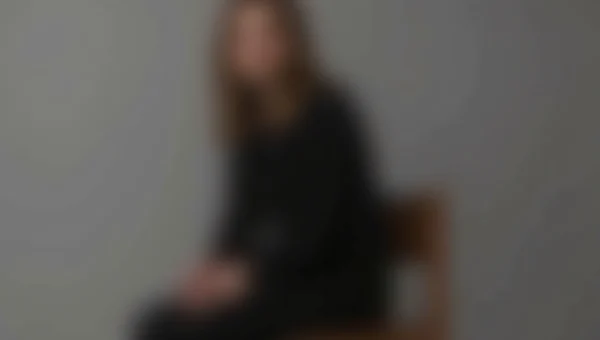 Casual Portrait of Individual on Wooden Stool