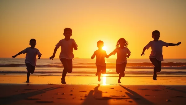 Children Silhouette Jumping on Shoreline at Sunset