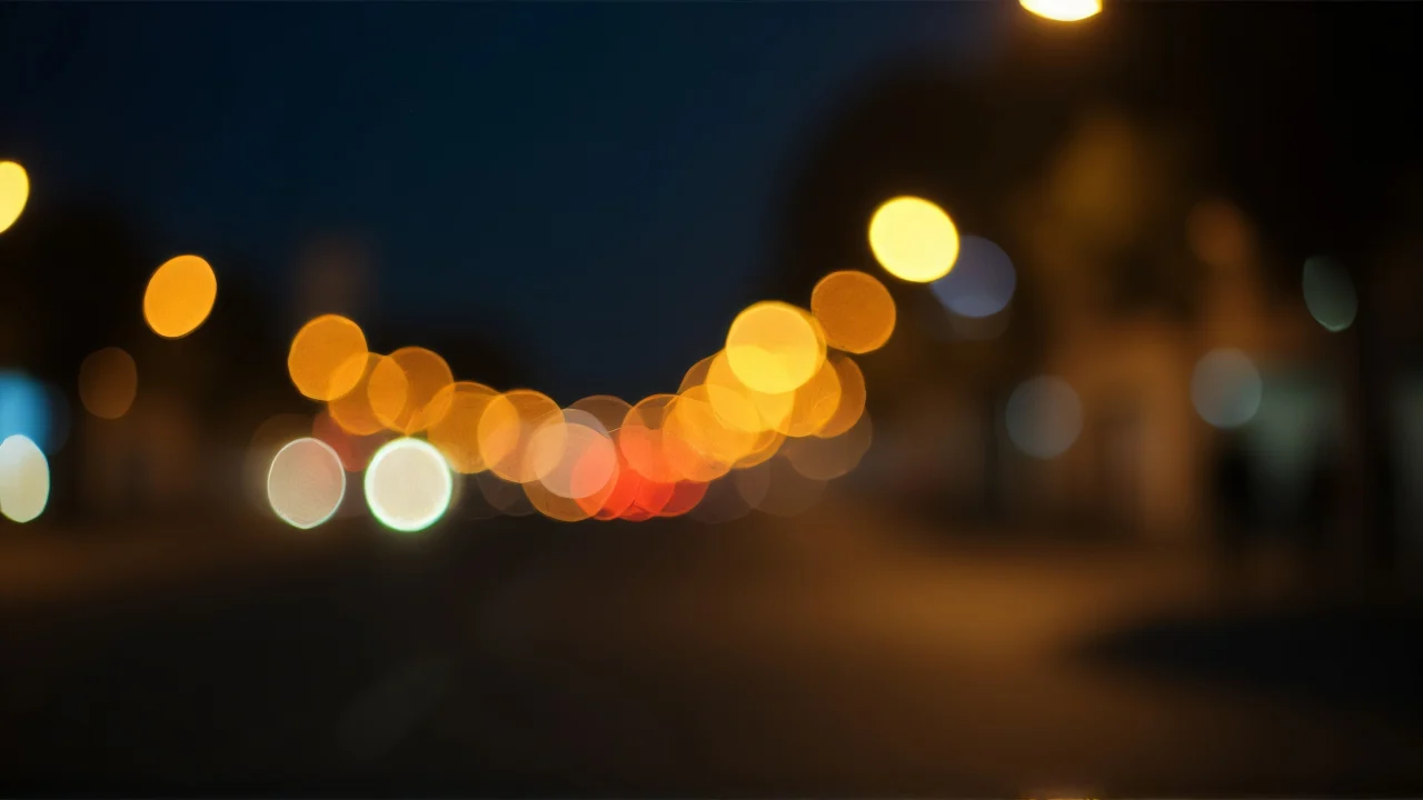 Close-up view of city nightscape with soft bokeh lights and dark background.
