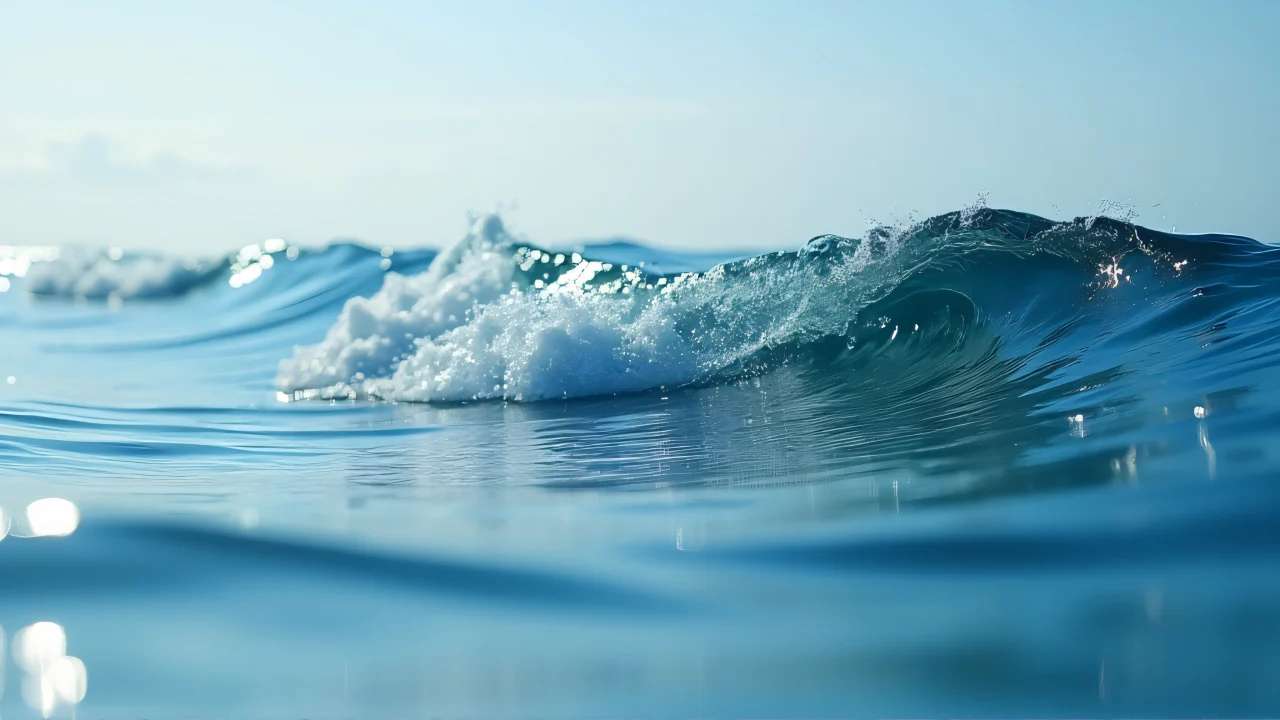 Close-up view of ocean surface with rippling water and reflections.