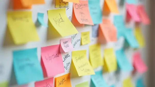 Colorful Sticky Notes Clustered On Wall