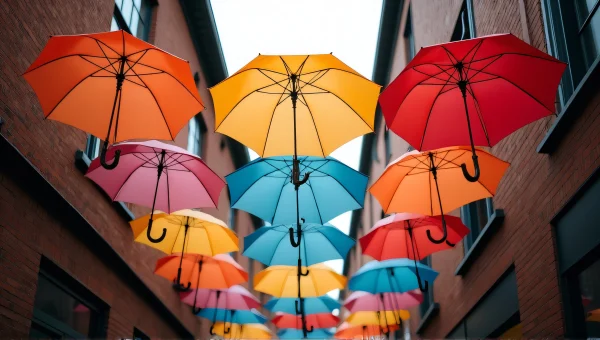 Colorful Umbrellas Over Narrow Street Scene