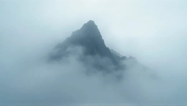 Craggy Mountain Peak Emerging From Fog