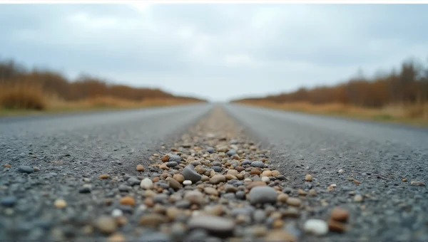 Empty Gravel Road Leading to Distant Horizon