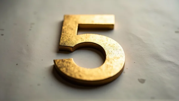 Gold Number 5 Close-Up On Textured Paper