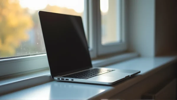 Gray Laptop on Windowsill with Morning Light
