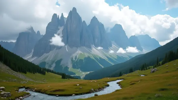 Jagged Mountain Range Under Clouds With Meadow