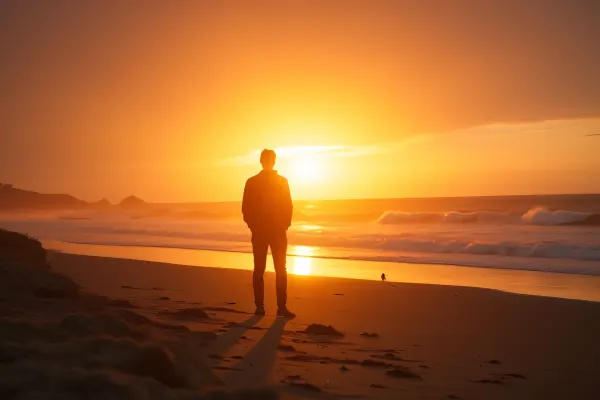 Lone Figure on Shoreline with Glowing Horizon