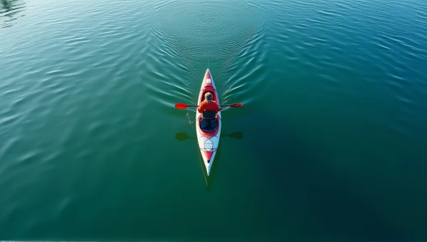 Lone Kayaker Paddling Calm Waters Aerial View