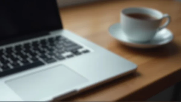 MacBook Pro and Teacup on Wooden Desk