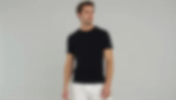 Male Model Black T-Shirt White Pants Relaxed Pose