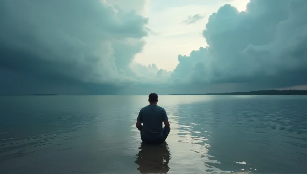 Man Kneeling at Lake Edge Under Dramatic Clouds