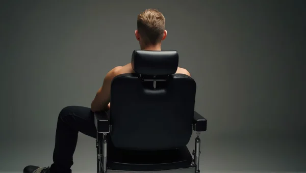 Man Seated on Black Leather Barber Chair