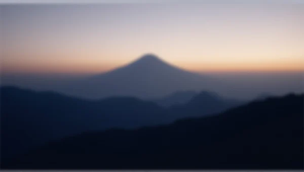 Mountain Silhouette At Dusk Over Shadowed Valley