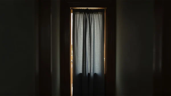 Narrow Hallway With Gray Curtain And Soft Lighting