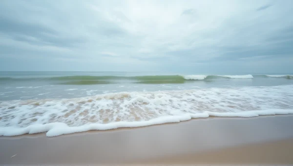 Ocean Wave Crashing On Sandy Shoreline Low Tide