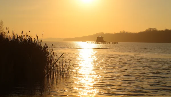River Sunset with Reeds and Pier Reflections