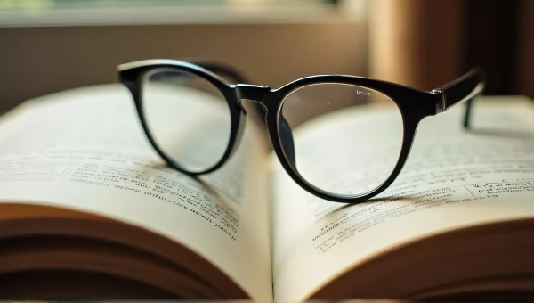 Round Eyeglasses On Open Hardcover Book