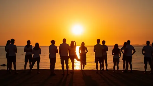 Silhouette Group of People on Shoreline at Sunset