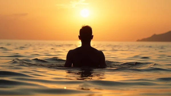 Silhouette Man in Sea at Golden Hour