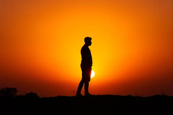 Silhouette of Person at Sunset Against Backlight