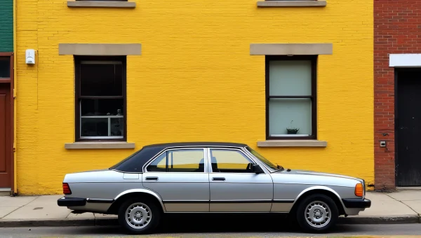 Silver Sedan Parked By Yellow Brick Building