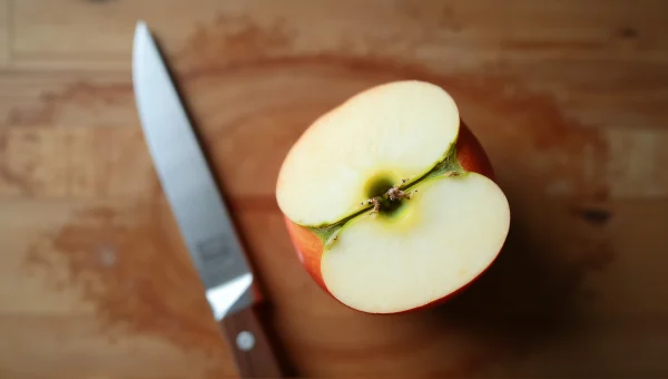 Sliced Apple With Knife On Wooden Cutting Board
