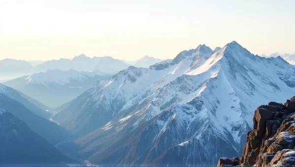 Snowy Mountain Peaks Under Pale Morning Sky