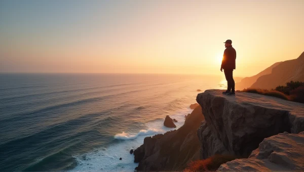 Solitary Man on Rocky Cliff Overlooking Ocean