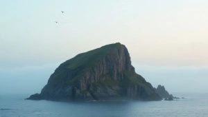 Solitary Rock Islet in Misty Sea at Dawn