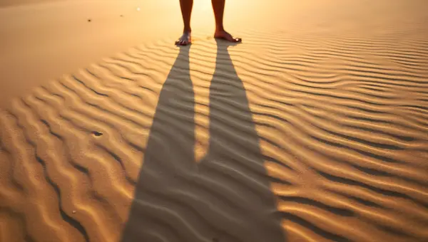 Standing Person Shadow On Rippled Beach Sand