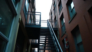 Street-Level View Of Metal Fire Escape Balcony