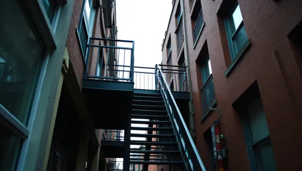 Street-Level View Of Metal Fire Escape Balcony