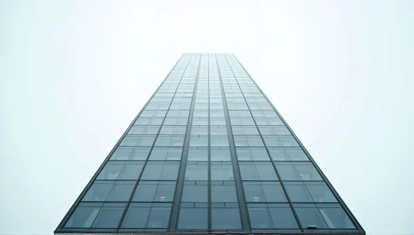 Tall Building Reflection Against Overcast Sky