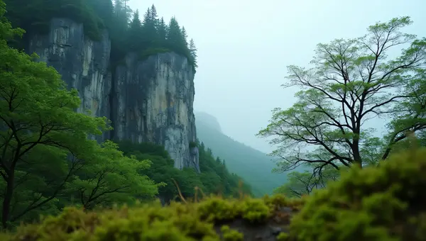 Towering Gray Rock Cliff Surrounded By Green Trees