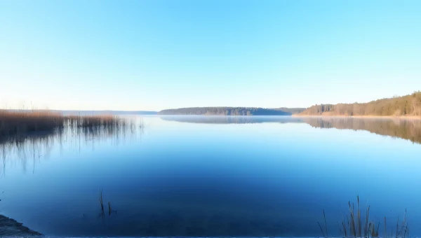 Tranquil Lake Reflection Under Blue Sky