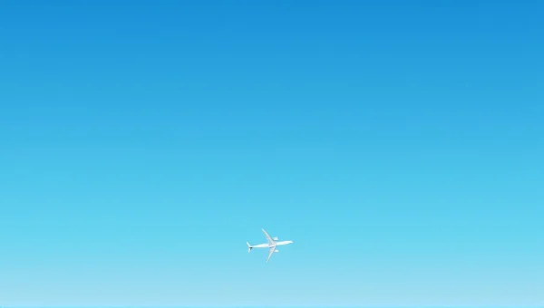 White Airplane Flying In Clear Blue Sky