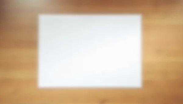 White Printer Paper On Wooden Desk With Soft Light