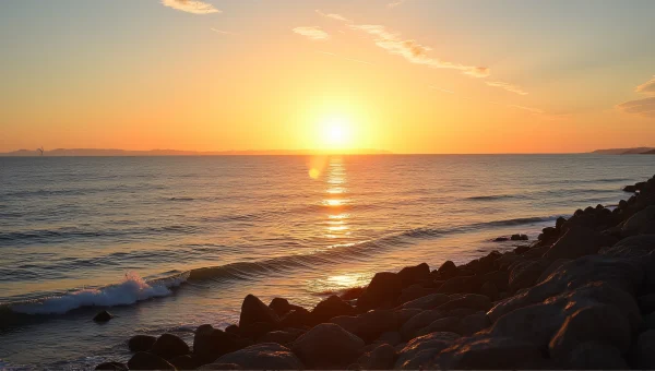 Wide Ocean at Golden Hour with Sailboat and Shore