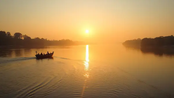 Wide River At Golden Hour With Solitary Rowboat