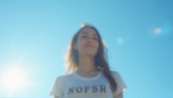 Woman Standing Under Blue Sky With Lens Flare