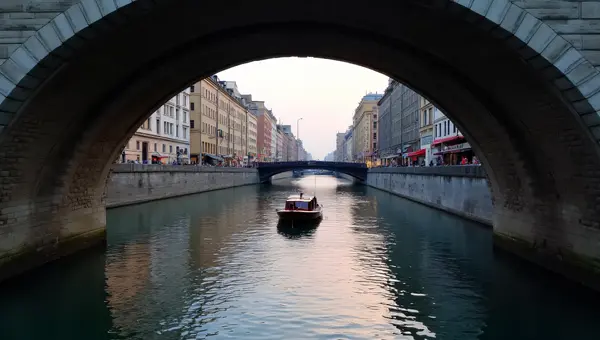 Wooden Boat On Calm River Under Bridge At Dusk