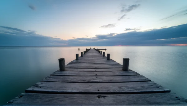 Wooden Pier At Dusk Over Calm Water Landscape
