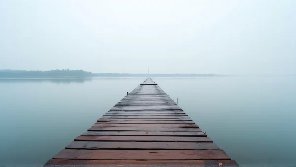 Wooden Staircase Over Calm Water With Mist