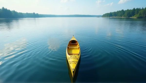Yellow Canoe On Calm Lake With Tree-Lined Shore